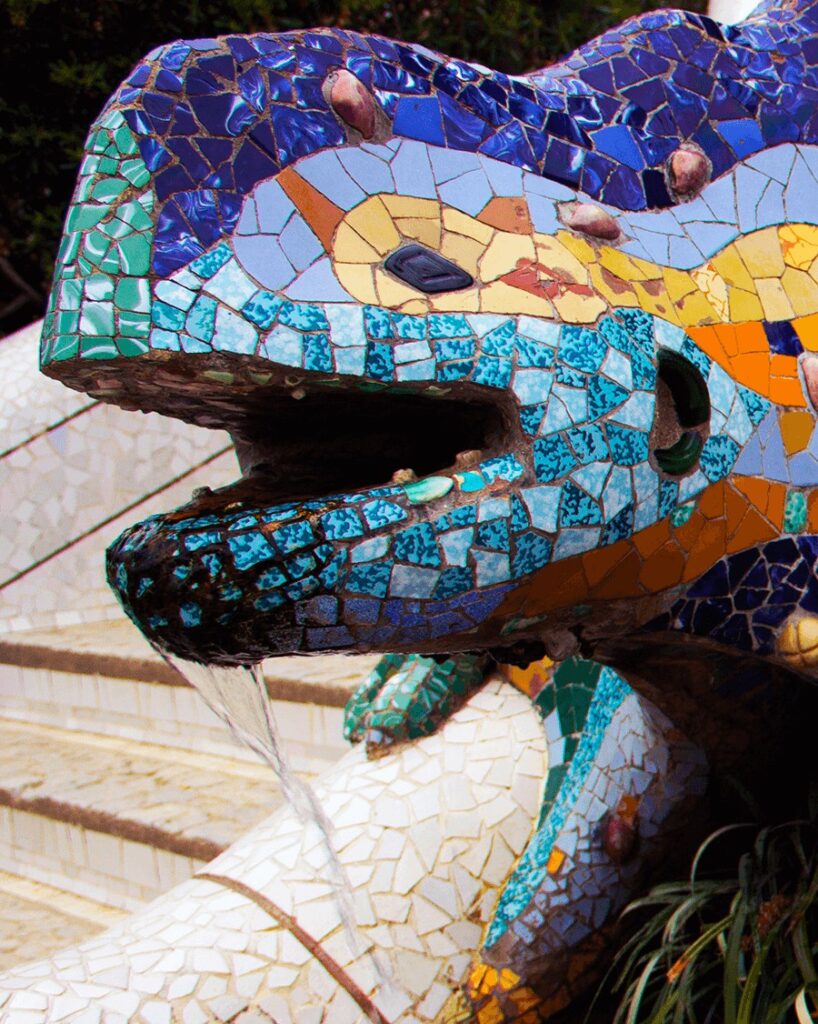 head of a shaped lizard water fountain in Parc Guell