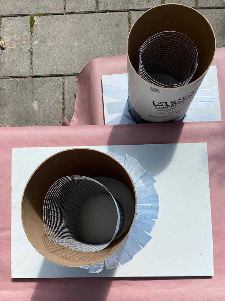 chicken wire reinforcement centered inside of cardboard concrete forms for making a table base