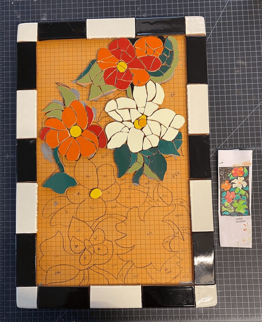 shaping the broken mosaic tile and building the blossoms and leaves for the mandevilla tabletop